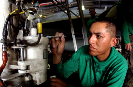 US Navy 050623-N-0413R-071 U.S. Marine Corps Cpl. Bradley Stewart, assigned to the Red Devils of Marine Fighter Attack Squadron Two Three Two (VMFA-232), applies touch-up paint during corrosion control maintenance on the nose l