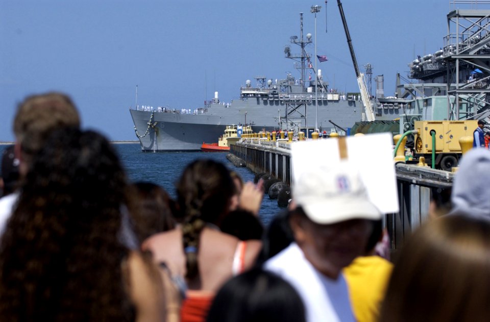 US Navy 050606-N-9866B-002 Families and friends of Sailors assigned aboard the amphibious dock landing ship USS Duluth (LPD 6) wait patiently as the ship pulls in to San Diego