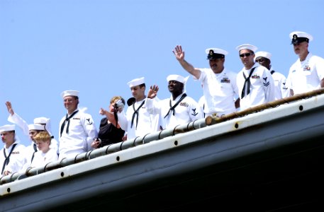 US Navy 050606-N-9866B-027 Sailors aboard the amphibious dock landing ship USS Duluth (LPD 6) wave to their family members waiting on the pier as the ship pulls in to San Diego