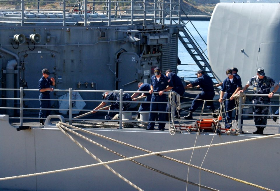 US Navy 050608-N-0780F-004 Crewmembers aboard the guided missile cruiser USS Philippine Sea (CG 58) handle mooring lines as they arrive at the Marathi Pier Facility in Greece for a port visit