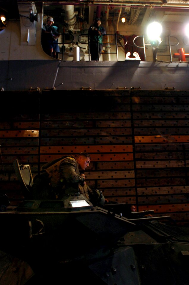 US Navy 050627-N-9866B-003 A Marine assigned to the 3rd Amphibious Assault Battalion based at Camp Pendelton, Calif., prepares to depart the well deck in an amphibious assault vehicle (AAV)