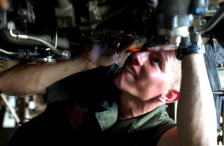 US Navy 050612-N-8158F-021 U.S. Marine Corps Lance Cpl. Travis Tracy removes the main fuel control unit on an F-A-18 Hornet in the hangar bay aboard USS Nimitz (CVN 68)