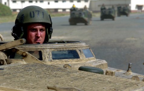 US Navy 050627-N-9866B-022 An amphibious assault vehicle (AAV) crew chief assigned to the 3rd Amphibious Assault Battalion based at Camp Pendelton, Calif., peers out of his hatch photo