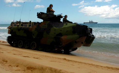 US Navy 050628-N-9866B-012 U.S. Marines assigned to 3rd Amphibious Assault Battalion, drive their Amphibious Assault Vehicles (AAVs) down the beach