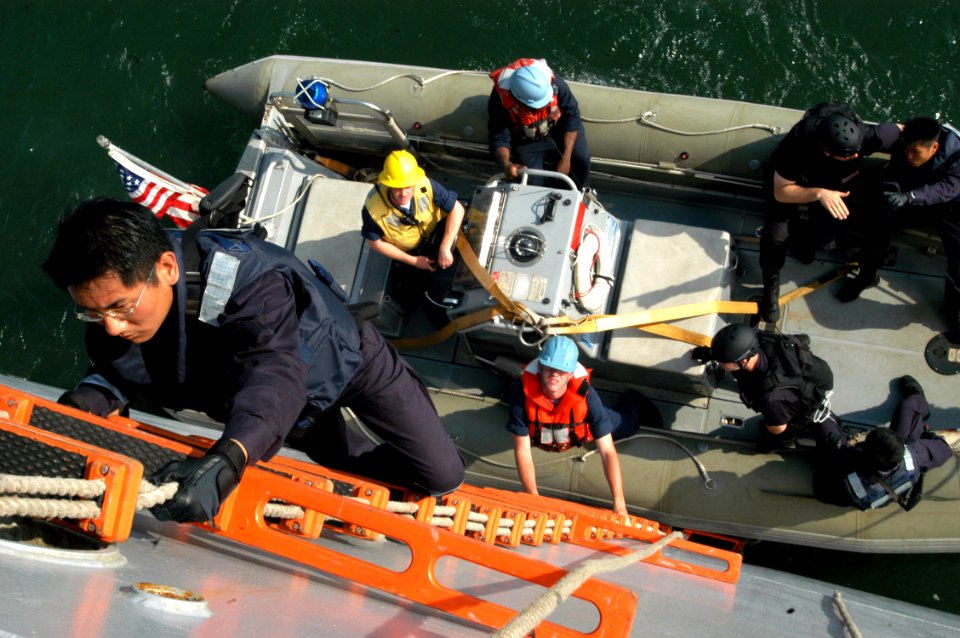 US Navy 050604-N-4104L-005 Republic of Singapore Navy Staff Sgt. Chiow Cheng Hai comes aboard the dock loading ship USS Fort McHenry (LSD 43) during a combined visit board, search and seizure (VBSS) exercise