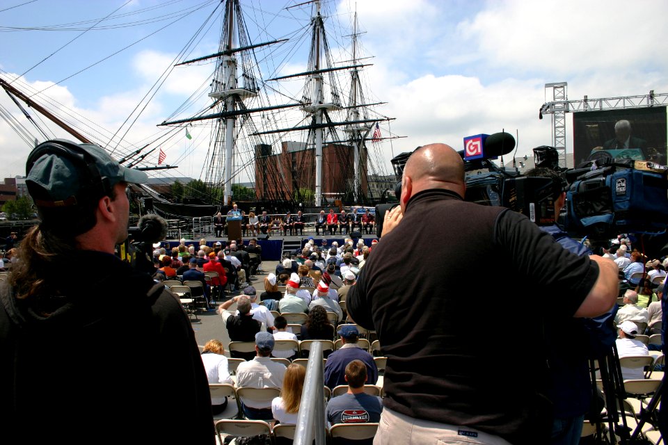 US Navy 050618-N-8110K-066 A local media cameraman zooms in on Boston City Commissioner Eugene Vaillancourt as he officially proclaims June 18, 2005, to be World War II Commemoration Day in Boston