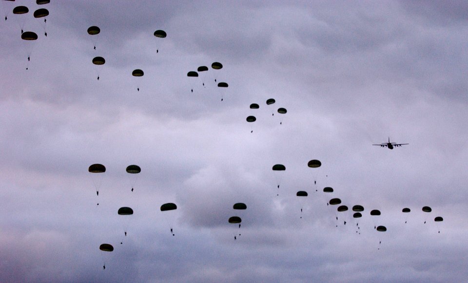 US Navy 050618-N-0000P-217 Australian Army Soldiers, assigned to the 3rd Royal Australian Regiment, conduct a dawn static line parachute jump from a C-130 Hercules aircraft