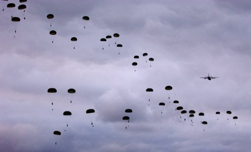 US Navy 050618-N-0000P-217 Australian Army Soldiers, assigned to the 3rd Royal Australian Regiment, conduct a dawn static line parachute jump from a C-130 Hercules aircraft