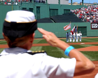 US Navy 050703-N-3286A-001 USS Bataan (LHD 5) Commanding Officer, Capt. Nora W. Tyson salutes the Bataan Color Guard during the playing of the National Anthem