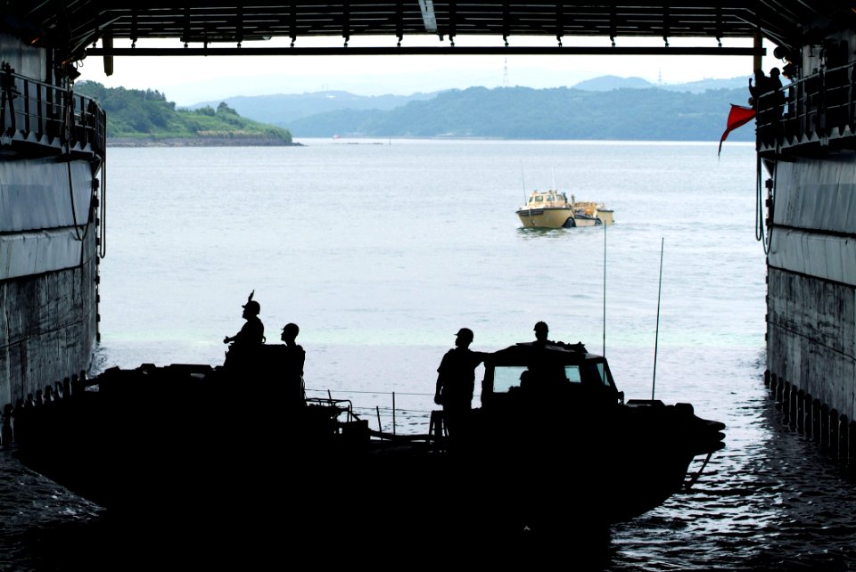 US Navy 050706-N-4772B-109 A pair of Light Amphibious Resupply Cargo (LARC) 5-ton vehicles, manned by members of Beachmaster Unit One, negotiate the well deck of USS Harpers Ferry (LSD 49)