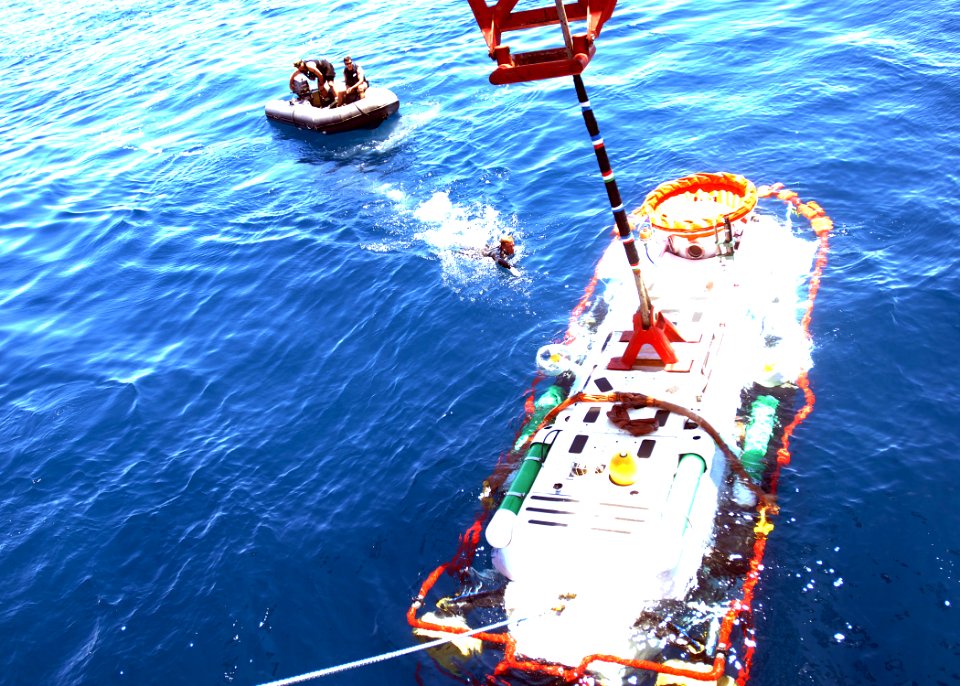 US Navy 050620-N-1464F-026 Petty Officer 3rd Class Richard Russell swims out to the United Kingdom's submarine rescue vehicle LR-5 to unhook the crane as it was lowered off the Finnish ship Fennica