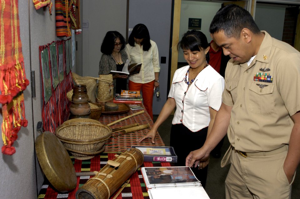 US Navy 050526-N-6477M-015 Chief Electrician's Mate Alexander O. Reyes assigned to Naval Station Everett, studies an exhibit of photos and artifacts from the Kalinga Tribe, from the Luzon Island of the Philippines