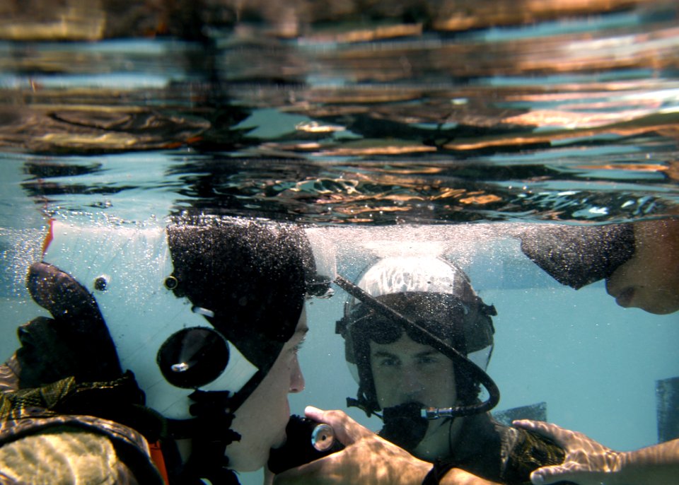 US Navy 050708-N-9500T-076 Two students submerge and breathe from SCUBA tanks as part of a familiarization course in the use of the Helicopter Emergency Escape Device at Aviation Survival Training Center