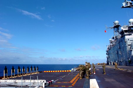 US Navy 050622-N-9866B-016 U.S. Marines, assigned to the 3rd Amphibious Assault Battalion, fire their M-16 rifles during a live-free weapon shoot on the flight deck aboard the amphibious assault ship USS Peleliu (LHA 5)