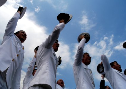 US Navy 050527-N-0295M-008 Newly commissioned Ensigns remove their covers prior to tossing them in the air as part of the U.S. Naval Academy class of 2005 graduation and commissioning ceremony photo