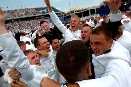 US Navy 050527-N-9693M-030 Newly commissioned officers celebrate their new positions with each other following the conclusion of the U.S. Naval Academy class of 2005 Graduation and Commissioning Ceremony photo