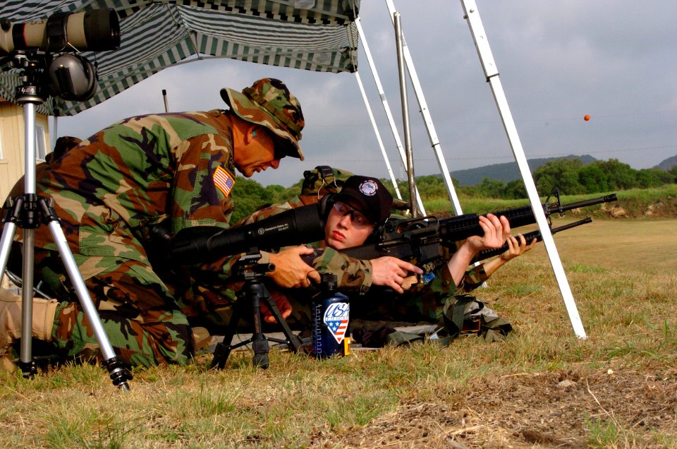 US Navy 050627-A-2545J-007 U.S. Army Reserve Sgt. Maj. Robert Payne, left, instructs U.S. Navy Midshipman Jake Rankinen on proper body positioning during live fire marksmanship training