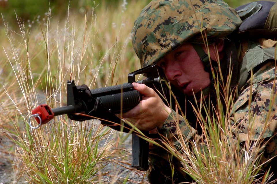 US Navy 050627-N-9866B-041 A U.S. Marine aims his M-16 rifle, armed with blanks, during infantry training