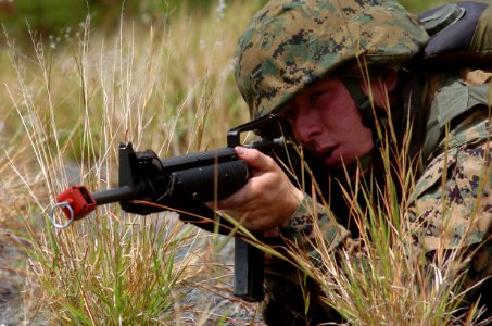 US Navy 050627-N-9866B-041 A U.S. Marine aims his M-16 rifle, armed with blanks, during infantry training