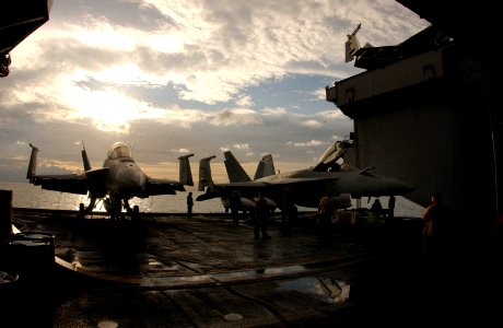 US Navy 050629-N-0413R-074 Aircraft elevator one prepares to transport aircraft to the flight deck from the hangar bay aboard the nuclear-powered aircraft carrier USS Nimitz (CVN 68) photo