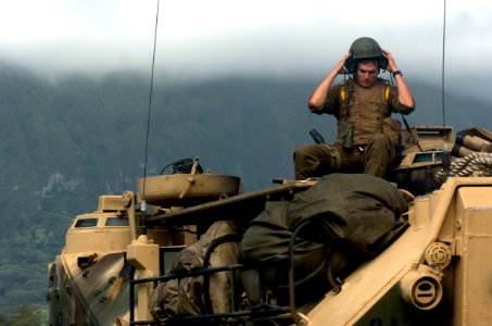 US Navy 050627-N-9866B-069 A U.S. Marine removes his crew helmet after a day of infantry training in the jungles of Hawaii