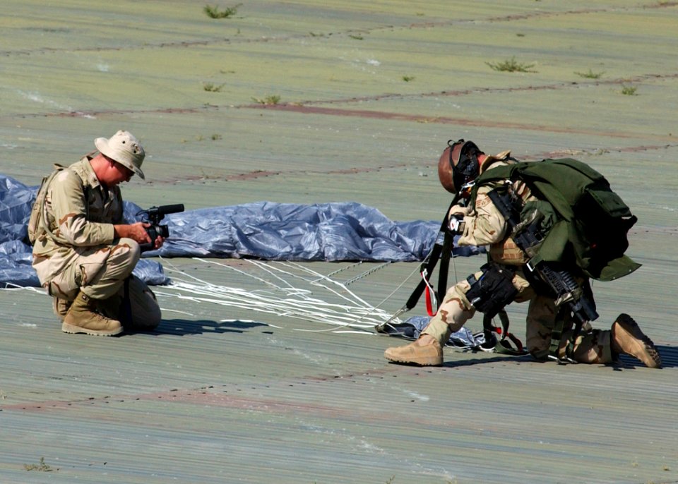 US Navy 050714-N-9500T-038 Photographer's Mate 2nd Class Greg Badger, assigned to Combat Camera Group Pacific, videotapes a Pararesuceman assigned to the U.S. Air Force's 48th Rescue Squadron