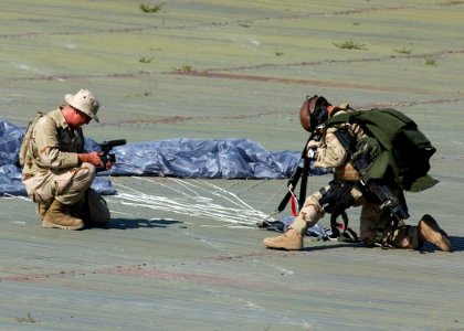 US Navy 050714-N-9500T-038 Photographer's Mate 2nd Class Greg Badger, assigned to Combat Camera Group Pacific, videotapes a Pararesuceman assigned to the U.S. Air Force's 48th Rescue Squadron