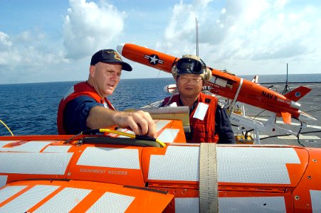 US Navy 050607-N-4104L-001 U.S. Navy Chief Warrant Officer Douglas Park points out the parachute doors and discusses recovery procedures on a BQM-74E aerial target drone