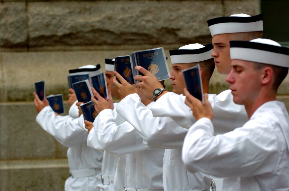 US Navy 050629-N-9693M-184 First day Midshipmen stand at attention while reading Reef Points, the manual for Midshipmen at the United States Naval Academy in Annapolis, Md