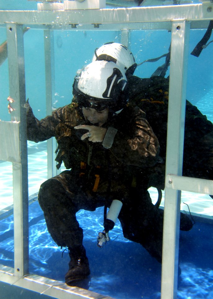US Navy 050708-N-9500T-149 A student breathes from a Helicopter Emergency Egress Device while exiting a training device at Aviation Survival Training Center (ASTC) on board Marine Corps Air Station (MCAS) Miramar