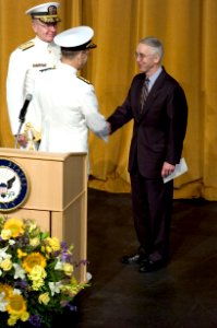 US Navy 050722-N-0295M-017 Adm. Mike Mullen is congratulated by Secretary of the Navy Gordon England after the reading of his official orders during the Chief of Naval Operations change of command ceremony