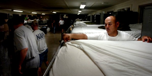 US Navy 050726-N-9769P-005 Aerographer's Mate 2nd Class Mariano Hunter changes linen on racks to make way for patients suffering from heat related injuries during the National Scout Jamboree held at Fort A.P. Hill, Va