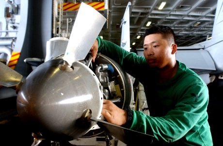 US Navy 050723-N-0413R-071 Aviation Structural Mechanic 3rd Class Johan Sanchez of Strike Fighter Squadron Four One (VFA-41), checks the hydraulic lines and blades of an aerial refueling system photo