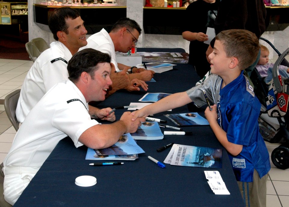 US Navy 050727-N-0000X-001 Submariners assigned to the Los Angeles-class attack submarine USS Cheyenne (SSN 773) sign photos of their Pearl Harbor-based submarine at the Frontier Mall in Cheyenne, Wyo