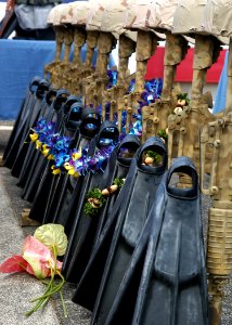 US Navy 050711-N-3019M-013 A flower rests in front of a ceremonial formation of U.S. Navy SEAL equipment during a memorial service for five Sailors assigned to SEAL Delivery Vehicle Team One (SDVT-1)