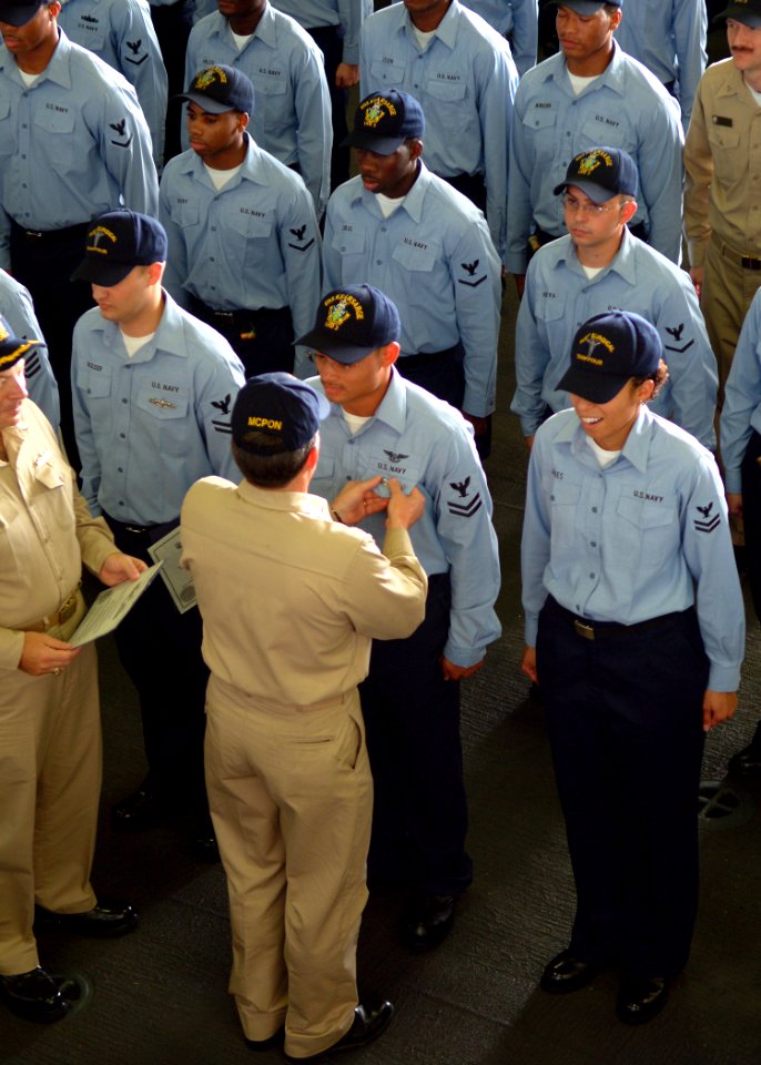 US Navy 050712-N-0962S-061 MCPON Terry Scott pins Enlisted Surface Warfare Specialist (ESWS) and Enlisted Aviation Warfare Specialist (EAWS) pins on nearly 50 Sailors
