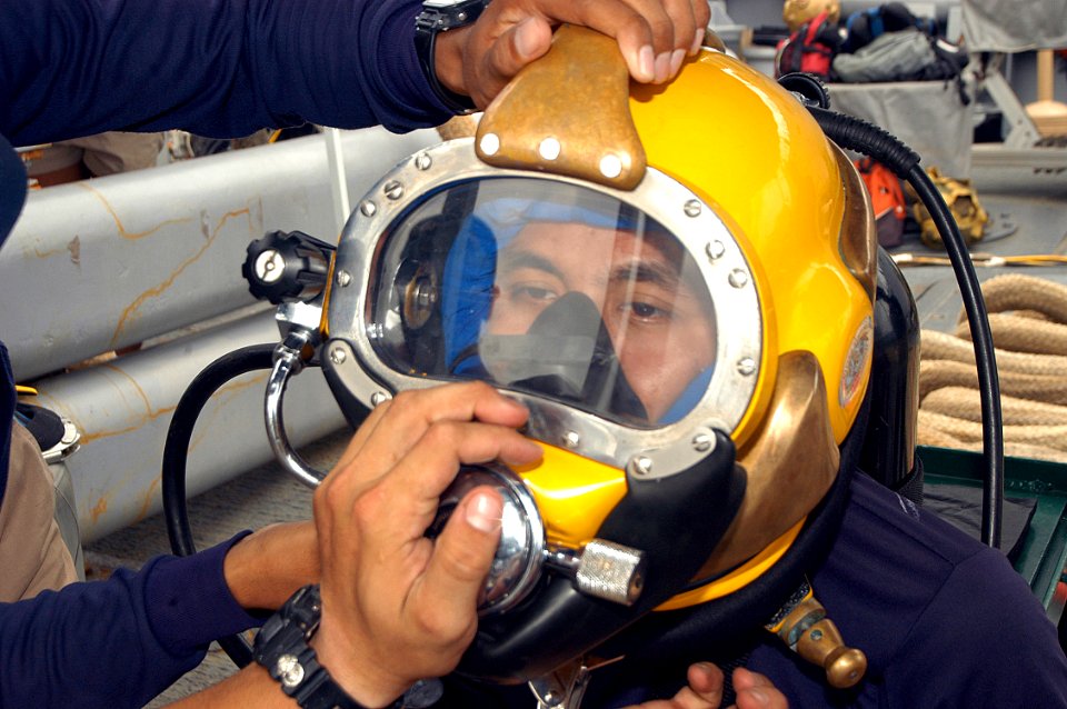 US Navy 050621-N-4104L-022 With the help of U.S. Navy divers assigned to the rescue and salvage ship USS Safeguard (ARS 50), a Royal Thai Navy (RTN) diver dons a MK-21 dive helmet in preparation for a combined U.S. Navy and RTN