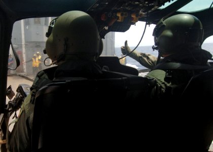 US Navy 050712-N-4374S-004 A Colombian AS 555 Fennec helicopter pilot gives a thumbs up signal to a U.S. Navy landing signal enlisted