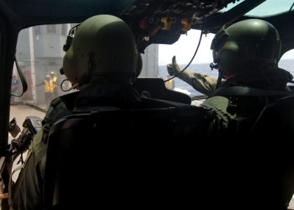 US Navy 050712-N-4374S-004 A Colombian AS 555 Fennec helicopter pilot gives a thumbs up signal to a U.S. Navy landing signal enlisted photo