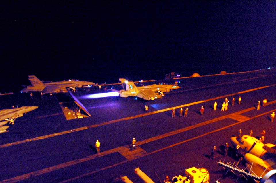 US Navy 050715-N-4843B-027 An F-A-18F Super Hornet oes to full afterburner prior to launching off the flight deck during night flight operations