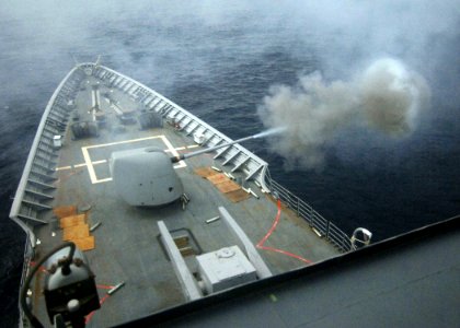 US Navy 050713-N-4374S-001 The guided missile cruiser USS Thomas S. Gates (CG 51) fires a training round from an MK-45 5-inch-54 caliber lightweight gun during a live fire exercise in the Pacific Ocean photo