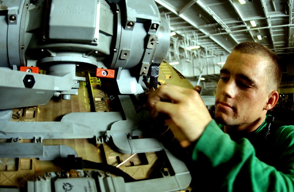 US Navy 050716-N-0413R-073 Aviation Electronics Technician 3rd Class Kurtis Lahr cleans a radar on an F-A-18E Super Hornet