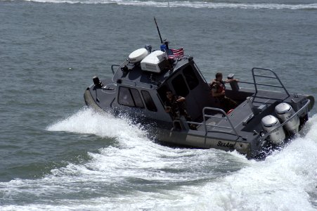 US Navy 050729-N-8154G-030 Sailors assigned to Naval Station Ingleside, Texas, make a high-speed turn while patrolling the waters near the base in a SeaArk boat photo