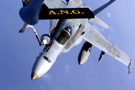 US Navy 050802-F-5040D-025 An F-A-18C Hornet receives fuel from a U.S. Air Force KC-135R Stratotanker during an aerial refueling mission over the Pacific Ocean photo