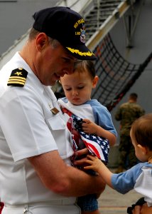US Navy 050716-N-0050T-002 Commanding Officer, USS Pearl Harbor (LSD 52), Cmdr. Jonathan Harden, says goodbye to his loved ones before his ship departs Naval Station San Diego photo