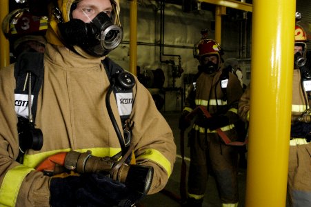 US Navy 050720-N-6477M-192 U.S. Coast Guard Boatswain's Mate 1st Class Wayne M. Gangstad stands by to enter a (mock) fire casualty space during Light Off Assessment (LOA) aboard the new littoral Surface Craft-Experimental
