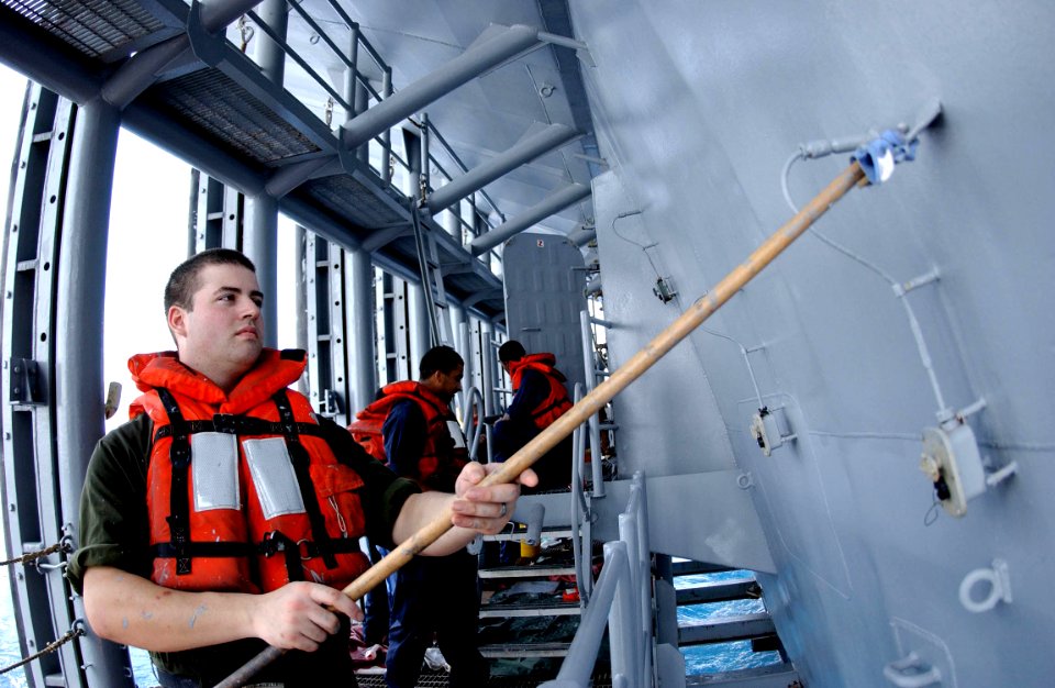 US Navy 050801-N-0413R-016 Seaman Trevor Pomeroy of Gigharbor, Wash., paints the stern dock aboard the nuclear-powered aircraft carrier USS Nimitz (CVN 68)