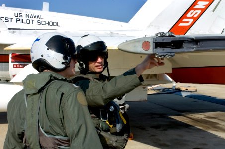 US Navy 050803-N-0295M-078 Flight Instructor, U.S. Marine Corps Maj. Michael Dehner, right, points out an item on the preflight checklist to student, Navy Lt. Christopher Dotson, prior to a flight from Naval Air Station Patuxen