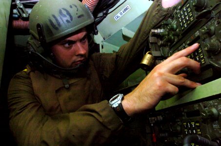 US Navy 050627-N-9866B-007 U.S. Marine Corps Cpl. Mark Johnston enters a radio frequency in his amphibious assault vehicle