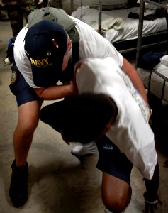 US Navy 050726-N-9769P-006 Hospital Corpsman Mike Borrall helps a Boy Scout to his feet after falling over due to a heat related injury during the National Scout Jamboree held at Fort A.P. Hill, Va